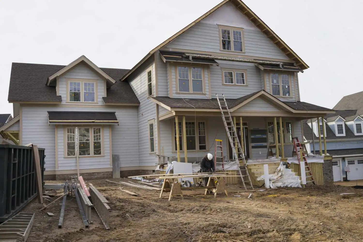 Two-story house under construction with unfinished framework and exposed beams - house addition contractors