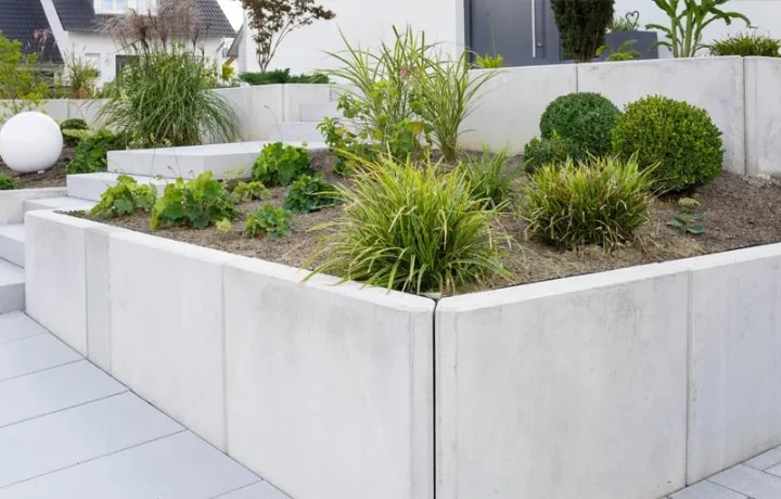 Modern concrete retaining walls with smooth finish and raised garden bed