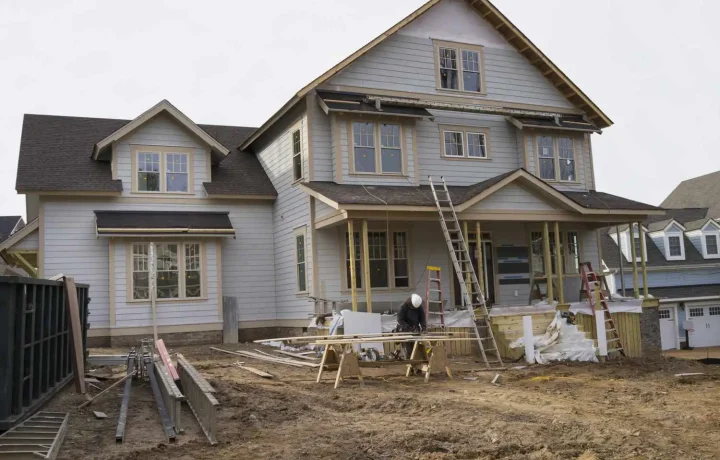 Two-story house under construction with unfinished framework and exposed beams - house addition contractors