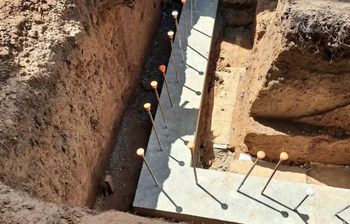 foundation site with concrete footing services work going on.