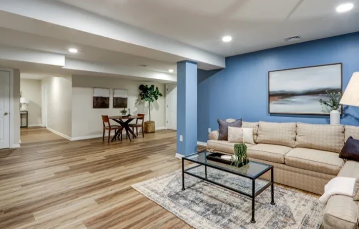 Finished basement with wood flooring, recessed lighting, and a beige sectional sofa