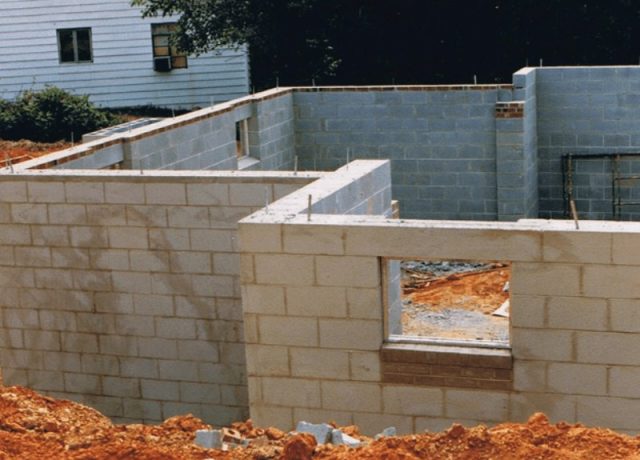 Partially constructed CMU block wall with scaffolding