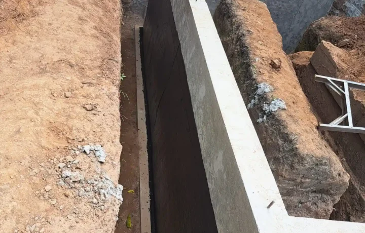 Close-up of foundation with black waterproofing material applied