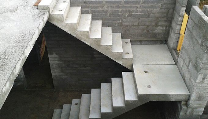 Indoor concrete staircase with clean design and gray brick wall