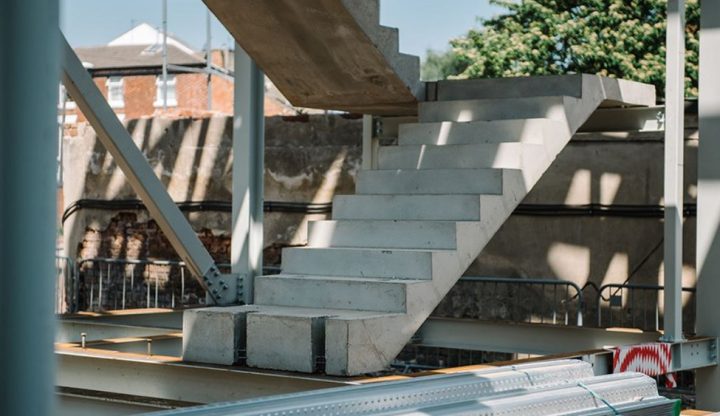 Partially constructed outdoor concrete staircase with metallic framework